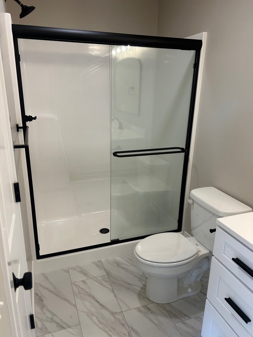 25179 North 2175 East Road Lexington, IL 61753 - Photo 10 of 23 a white toilet sitting next to a shower