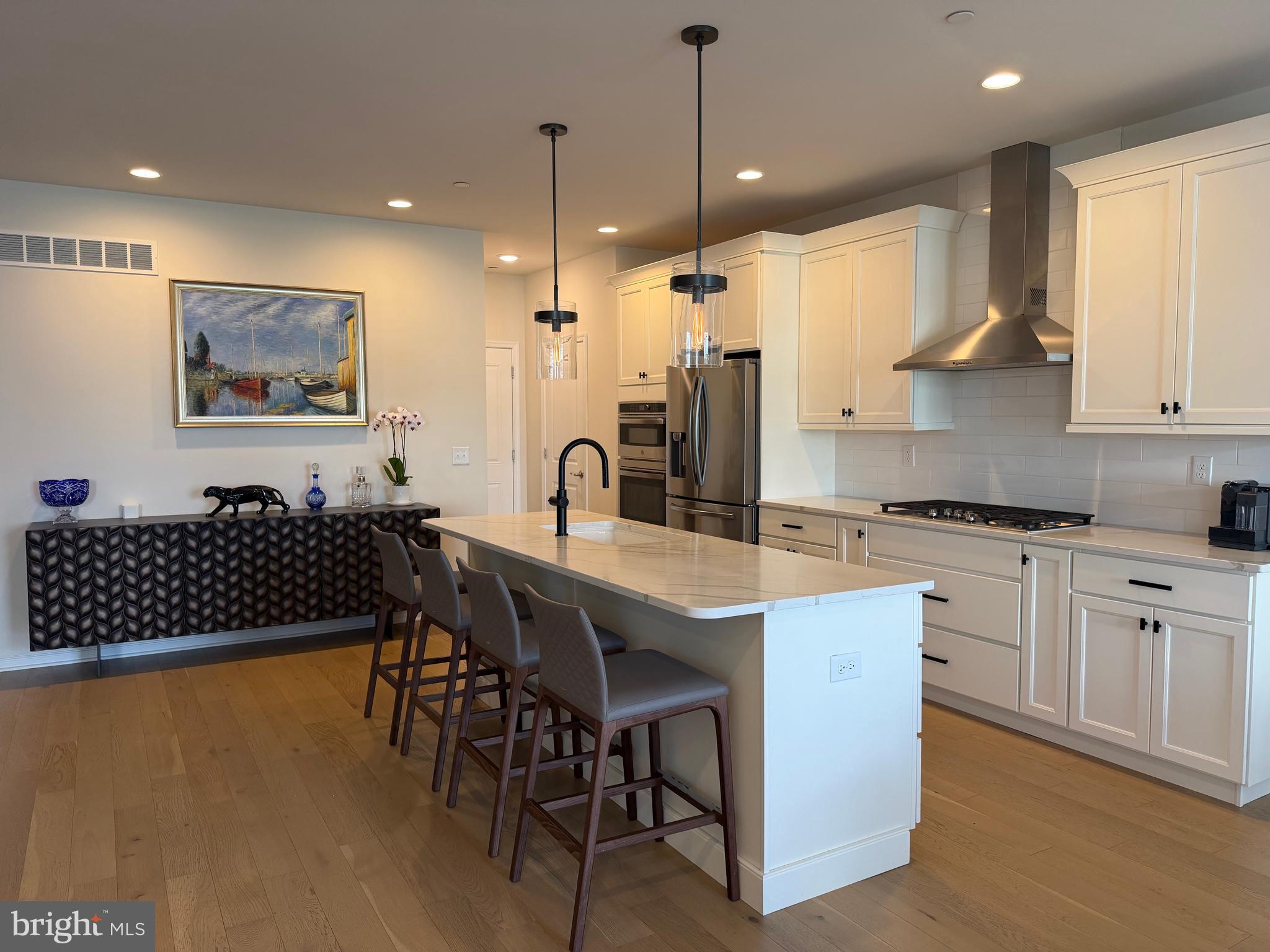 12 Spring Mill Drive Ivyland, PA 18974 - Photo 5 of 25 a kitchen with stainless steel appliances granite countertop a sink a stove a dining table and chairs