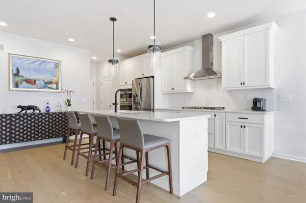 a kitchen with sink stove and wooden floor