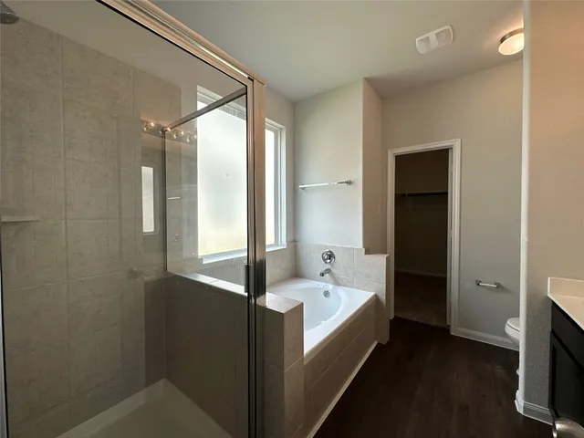 a bathroom with a tub and a double vanity sink