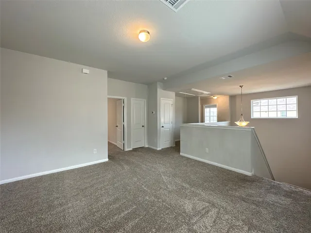 an empty room with windows and entrance