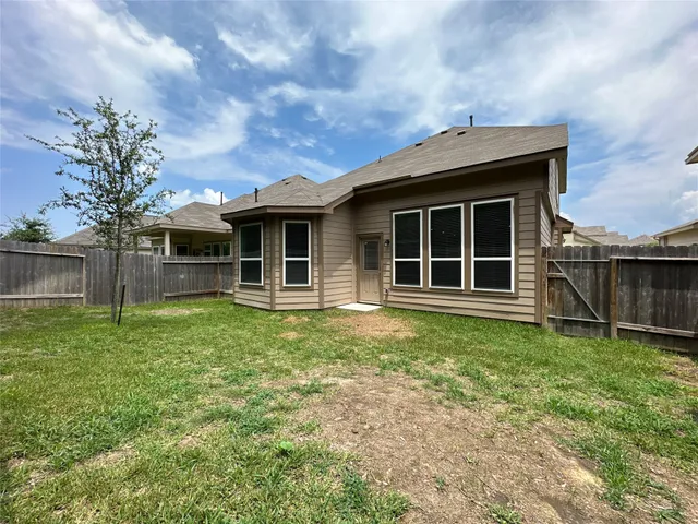 a house with green field in front of it