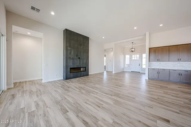 a open kitchen with stainless steel appliances granite countertop a stove and wooden floor