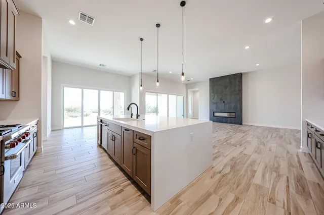 a kitchen with stainless steel appliances granite countertop a sink and a refrigerator
