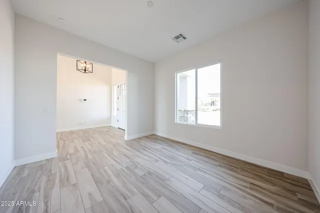 a view of kitchen with kitchen island wooden floor and center island