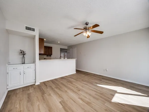 a view of a kitchen with microwave and a ceiling fan