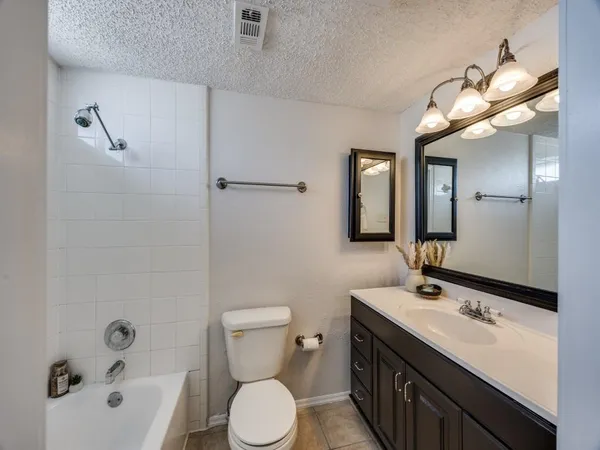 a bathroom with a double vanity sink toilet and shower