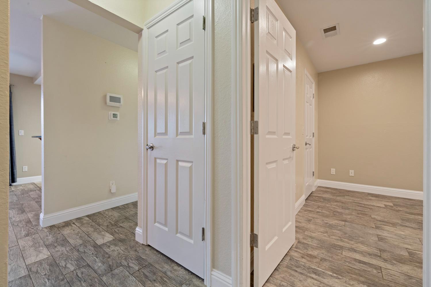 3901 Dale Road, Unit A Modesto, CA 95356 - Photo 12 of 23 a view of a hallway with wooden floor and a bathroom