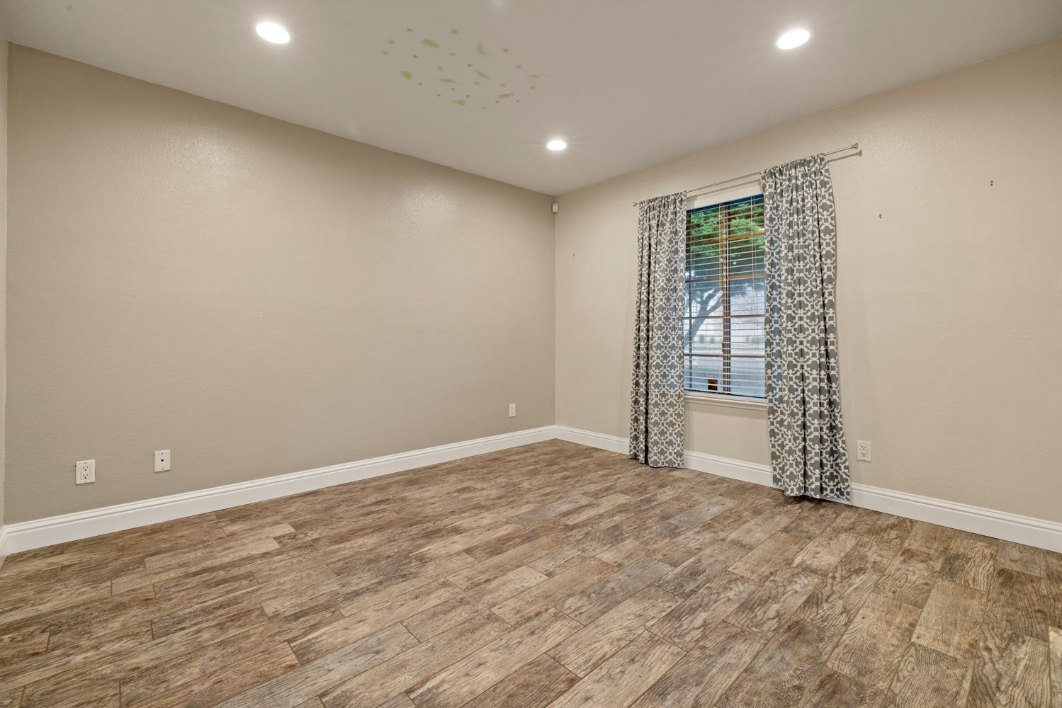 3901 Dale Road, Unit A Modesto, CA 95356 - Photo 13 of 23 wooden floor in an empty room with a window