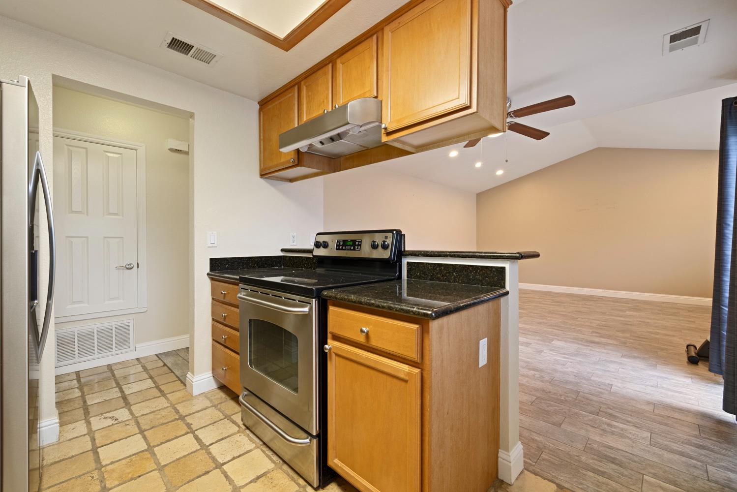 3901 Dale Road, Unit A Modesto, CA 95356 - Photo 6 of 23 a kitchen with stainless steel appliances granite countertop a stove and a refrigerator