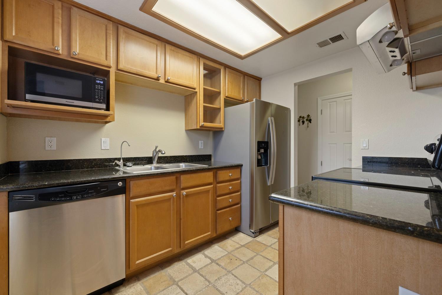 3901 Dale Road, Unit A Modesto, CA 95356 - Photo 7 of 23 a kitchen with stainless steel appliances granite countertop a refrigerator and a stove top oven