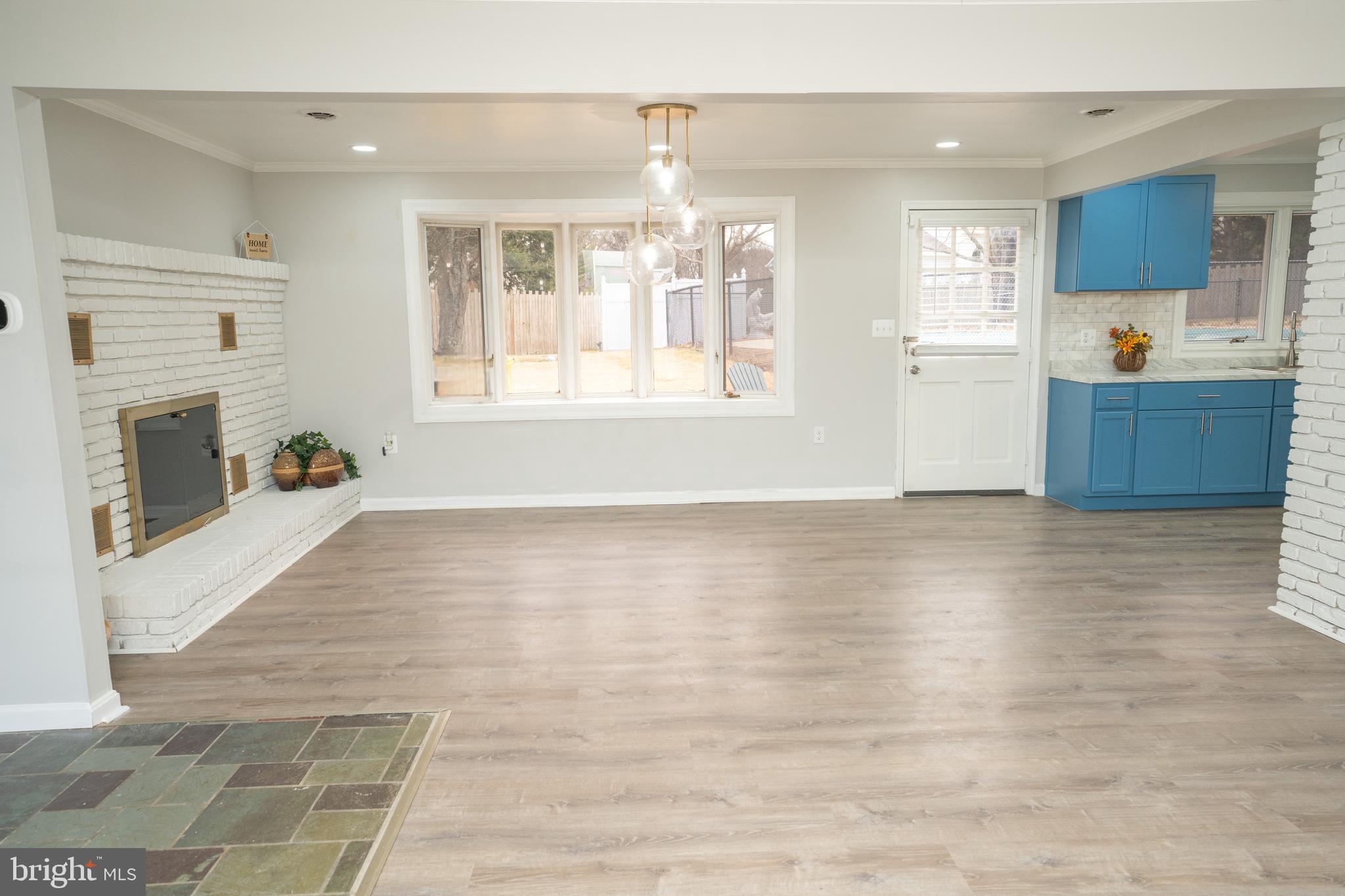 907 Reece Road Severn, MD 21144 - Photo 13 of 56 a view of an empty room with window and wooden floor