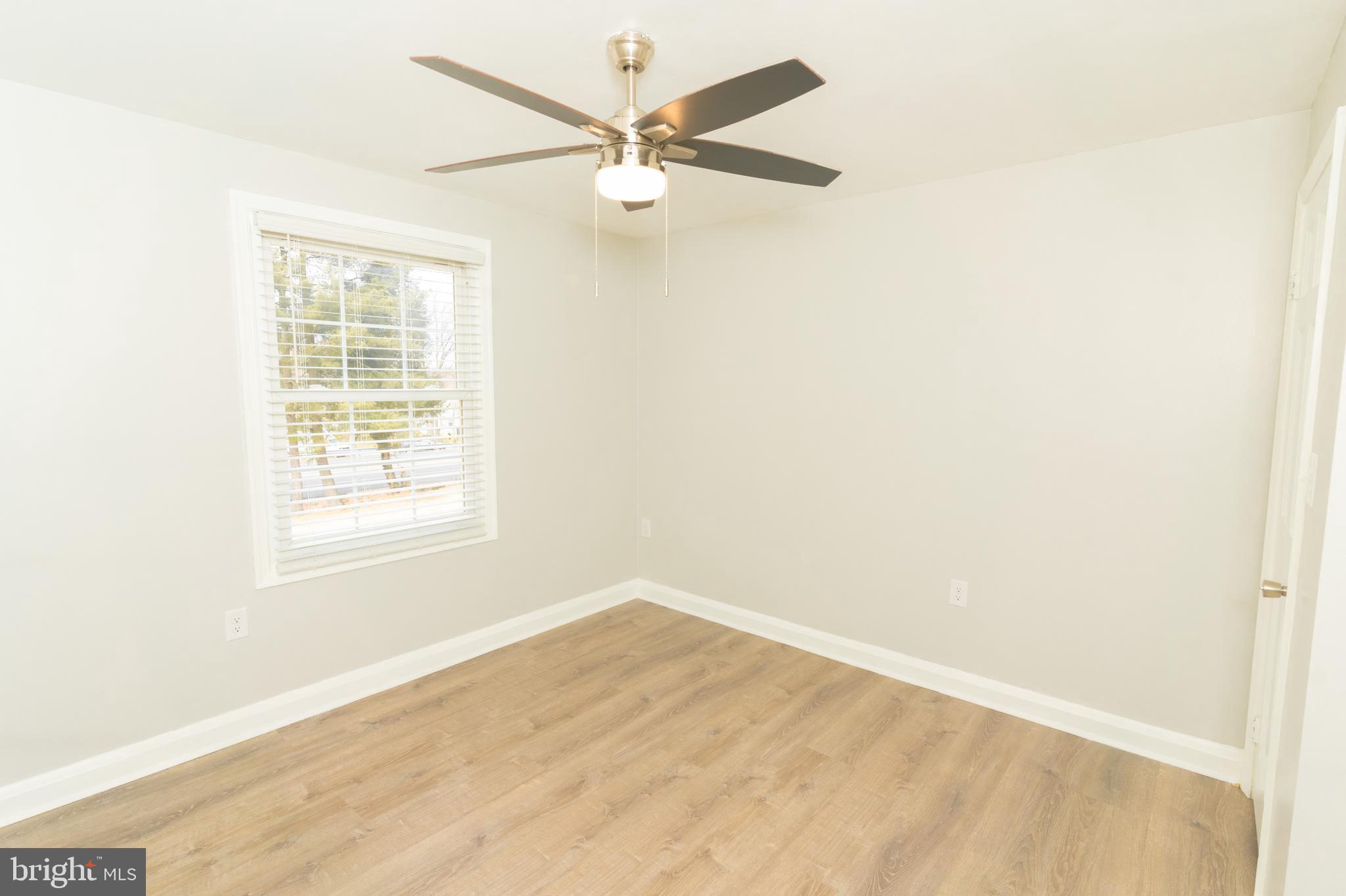 907 Reece Road Severn, MD 21144 - Photo 28 of 56 an empty room with a window and a fan