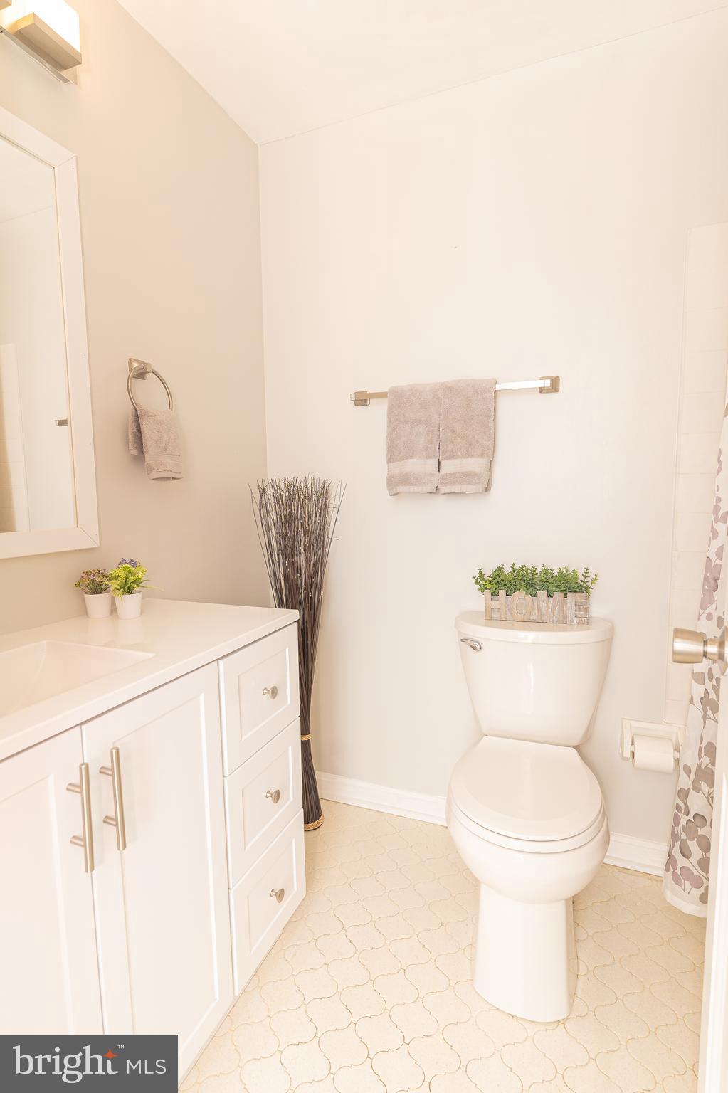 907 Reece Road Severn, MD 21144 - Photo 30 of 56 a bathroom with a toilet sink and mirror