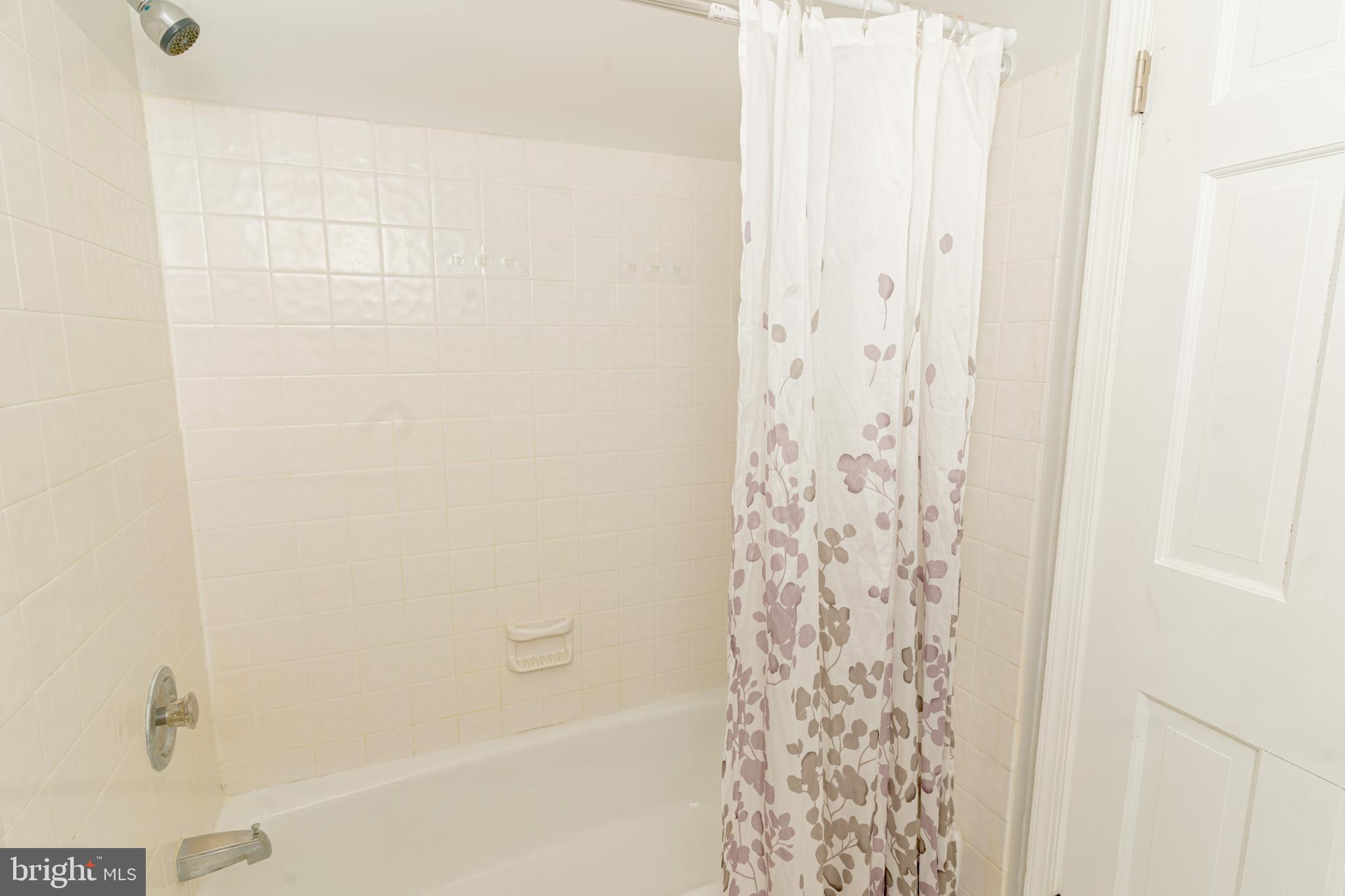 907 Reece Road Severn, MD 21144 - Photo 32 of 56 a bathroom with a shower curtain and a shower curtain