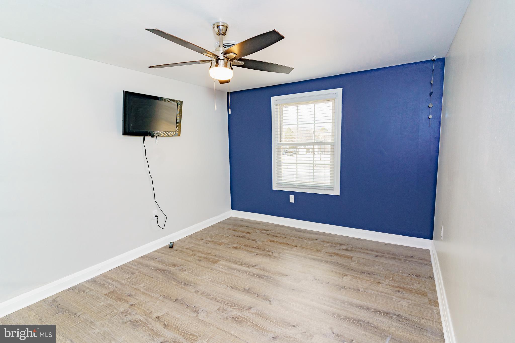 907 Reece Road Severn, MD 21144 - Photo 33 of 56 a view of an empty room with a window and a flat screen tv