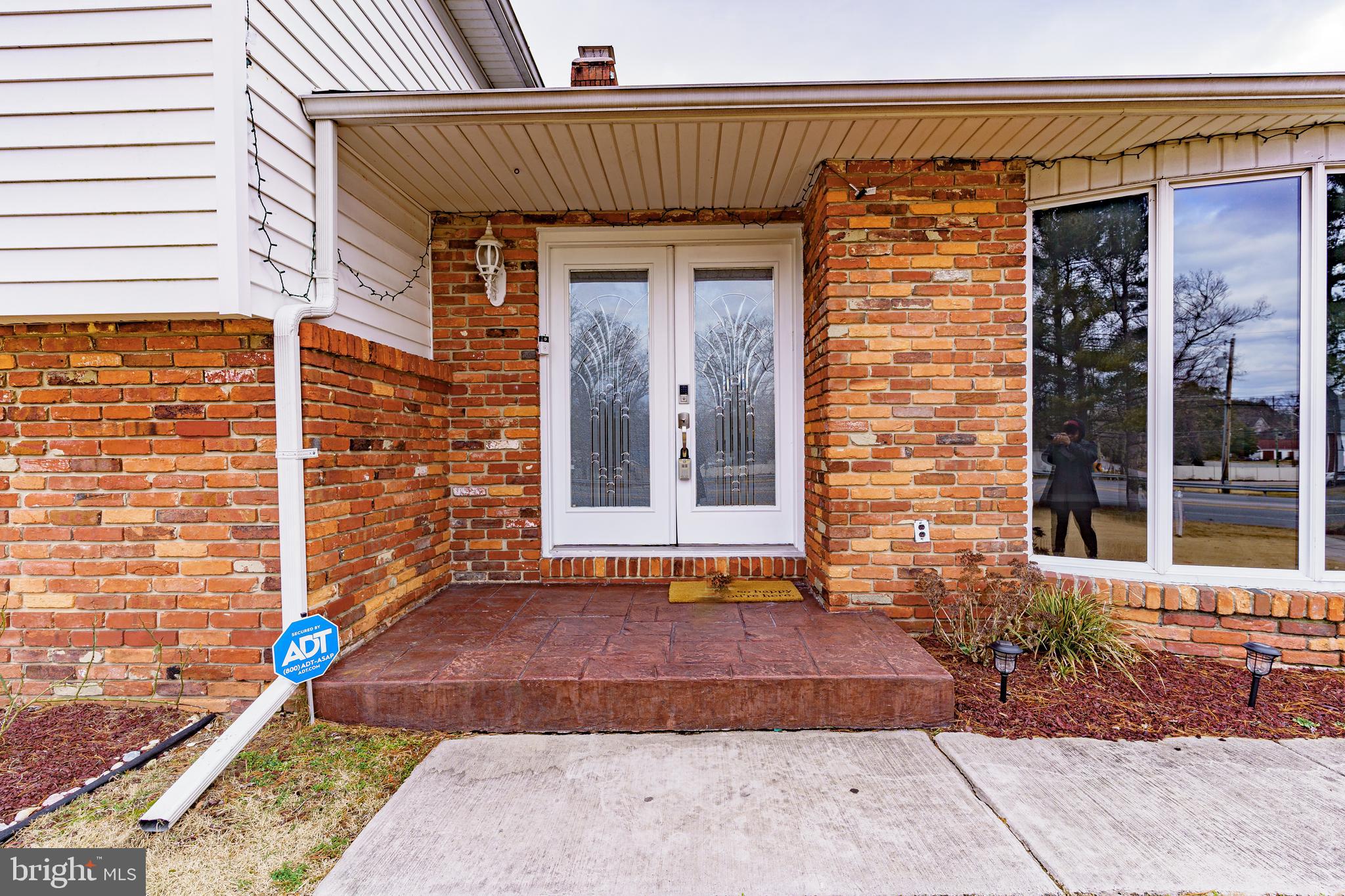 907 Reece Road Severn, MD 21144 - Photo 4 of 56 a front view of a house with a garage