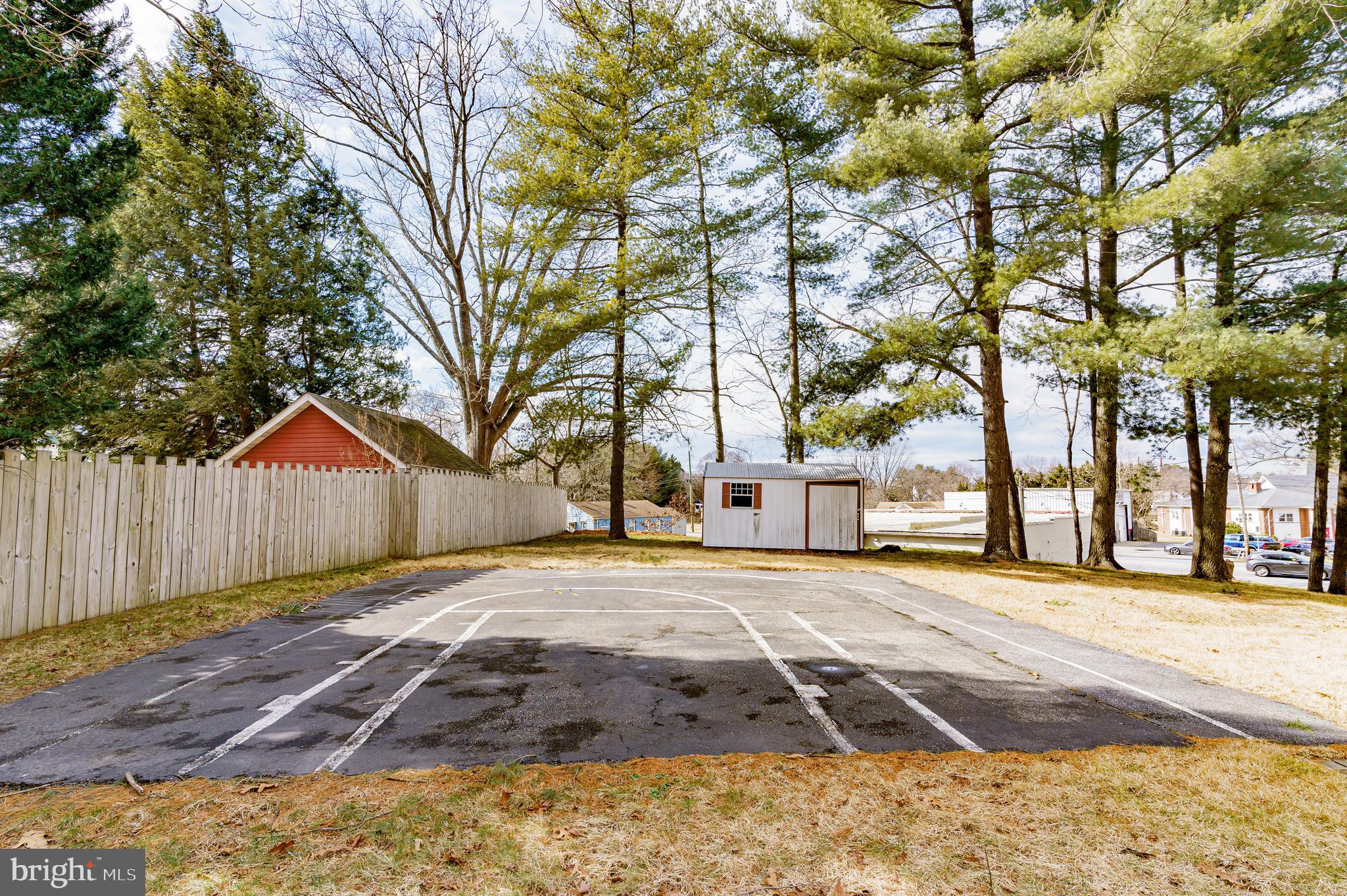 907 Reece Road Severn, MD 21144 - Photo 48 of 56 a front view of a house with a yard and trees
