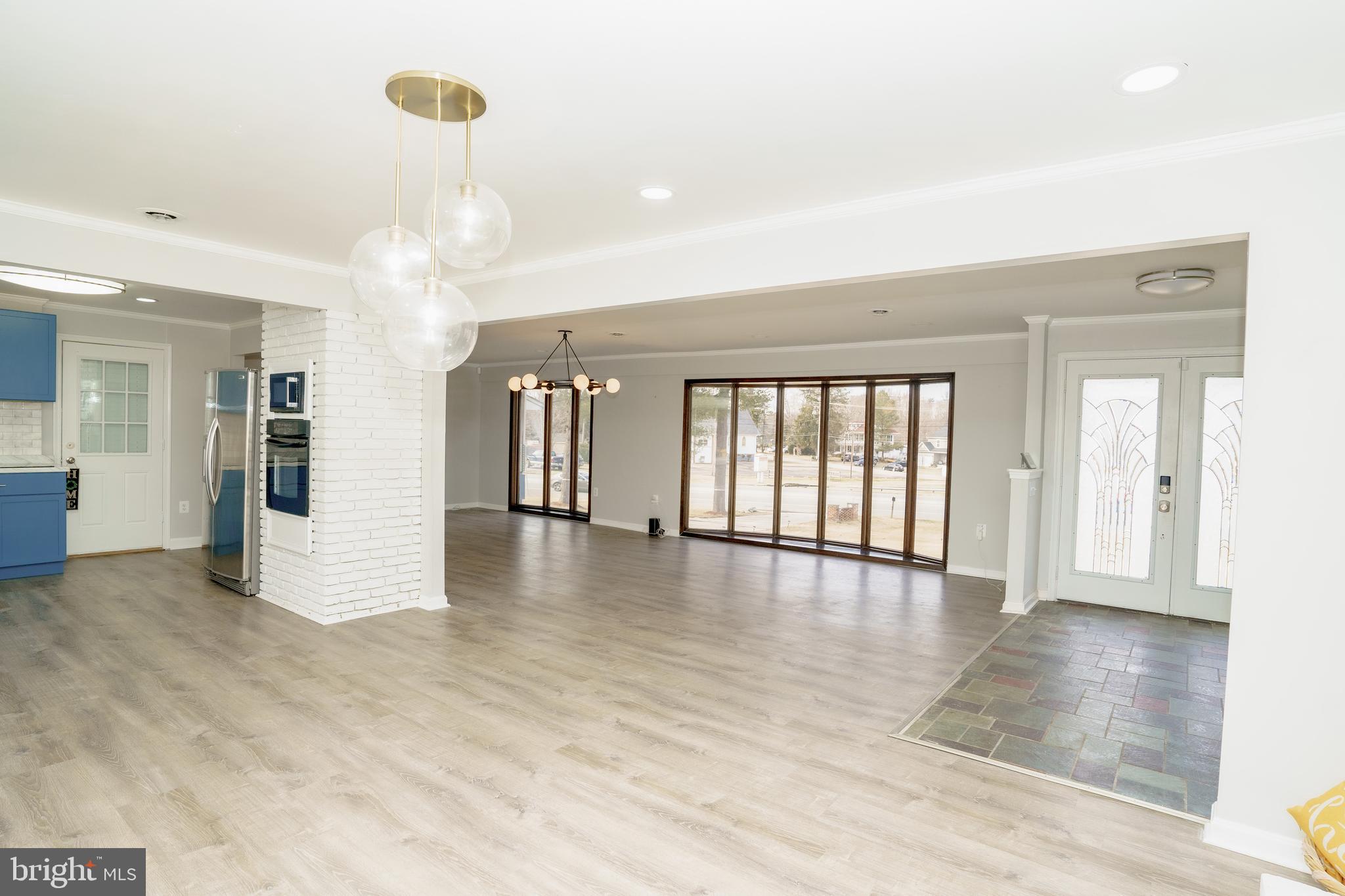 907 Reece Road Severn, MD 21144 - Photo 6 of 56 a view of an empty room with wooden floor and a window