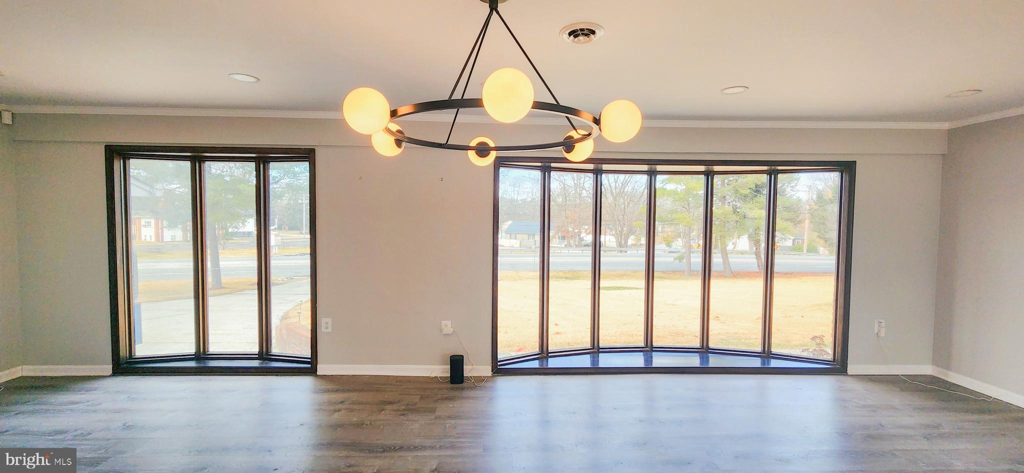 907 Reece Road Severn, MD 21144 - Photo 7 of 56 a view of empty room with wooden floor and fan