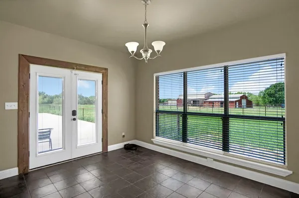 a large kitchen with kitchen island a counter top space a sink stainless steel appliances and cabinets