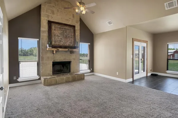 a view of an empty room with a fireplace