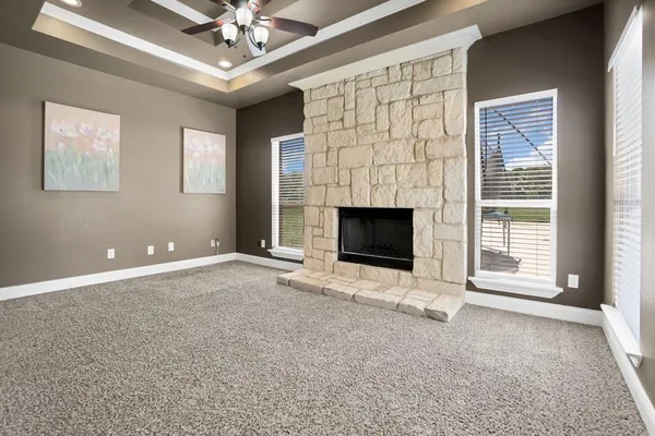 a view of livingroom with fireplace fan and windows