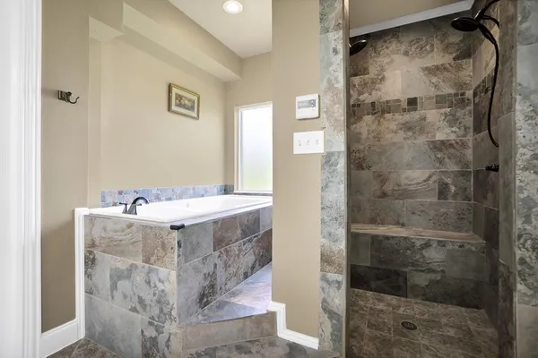 a bathroom with a shower and mirror