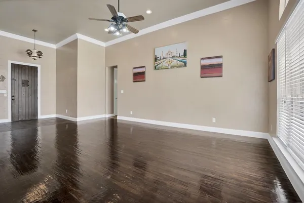 a kitchen with stainless steel appliances granite countertop a refrigerator a sink dishwasher a stove and white cabinets with wooden floor