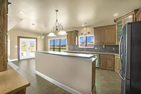 a kitchen with stainless steel appliances granite countertop a refrigerator and a sink