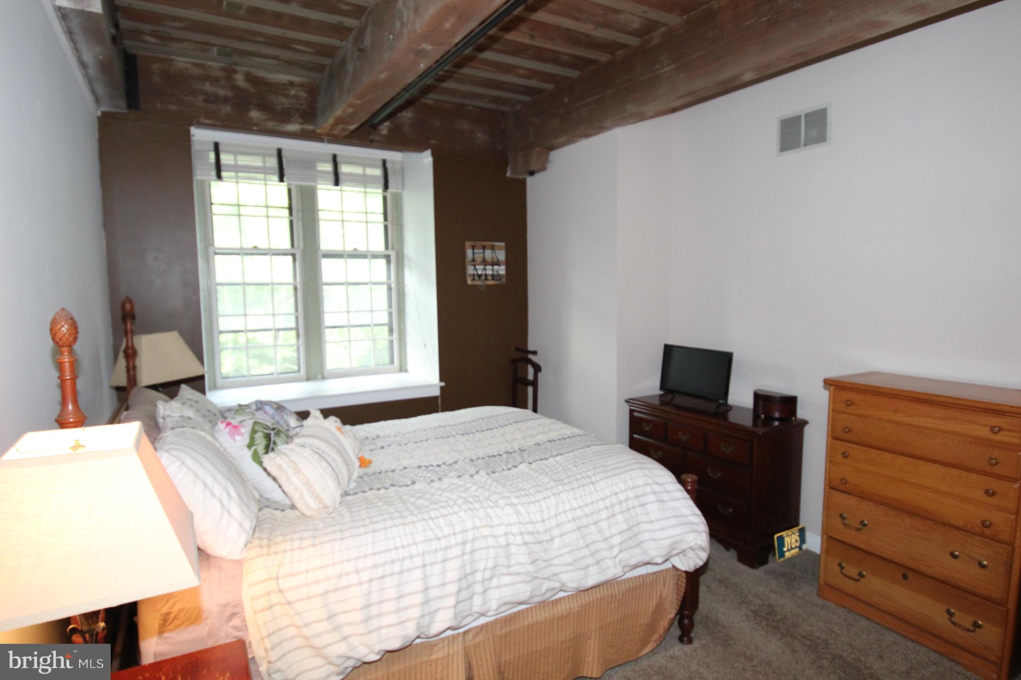 49 Bancroft Mills Road, Unit 3J Wilmington, DE 19806 - Photo 12 of 25 a bedroom with a bed and a window