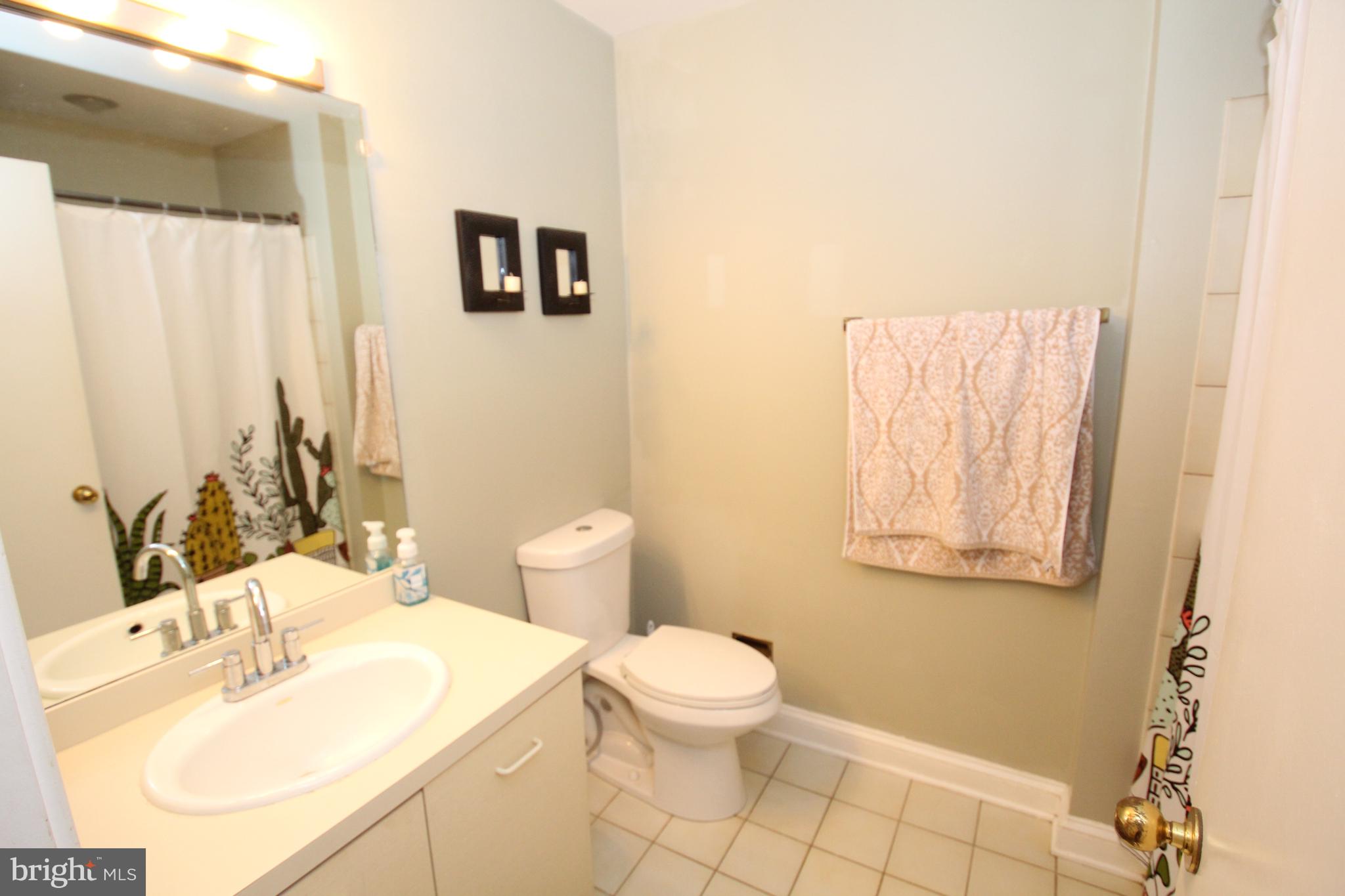49 Bancroft Mills Road, Unit 3J Wilmington, DE 19806 - Photo 17 of 25 a bathroom with a sink a toilet and mirror