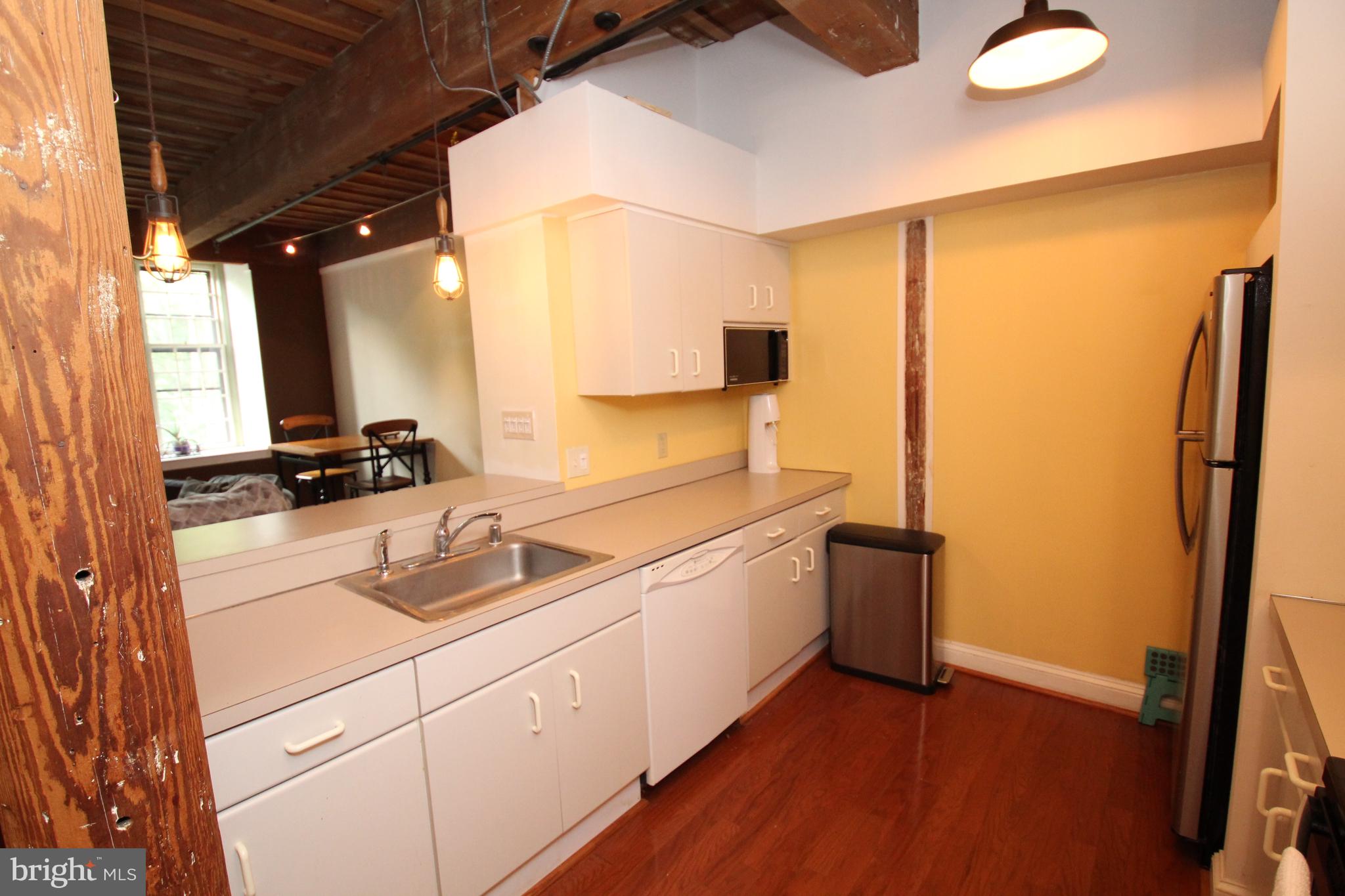 49 Bancroft Mills Road, Unit 3J Wilmington, DE 19806 - Photo 9 of 25 a kitchen with stainless steel appliances granite countertop a sink and a refrigerator