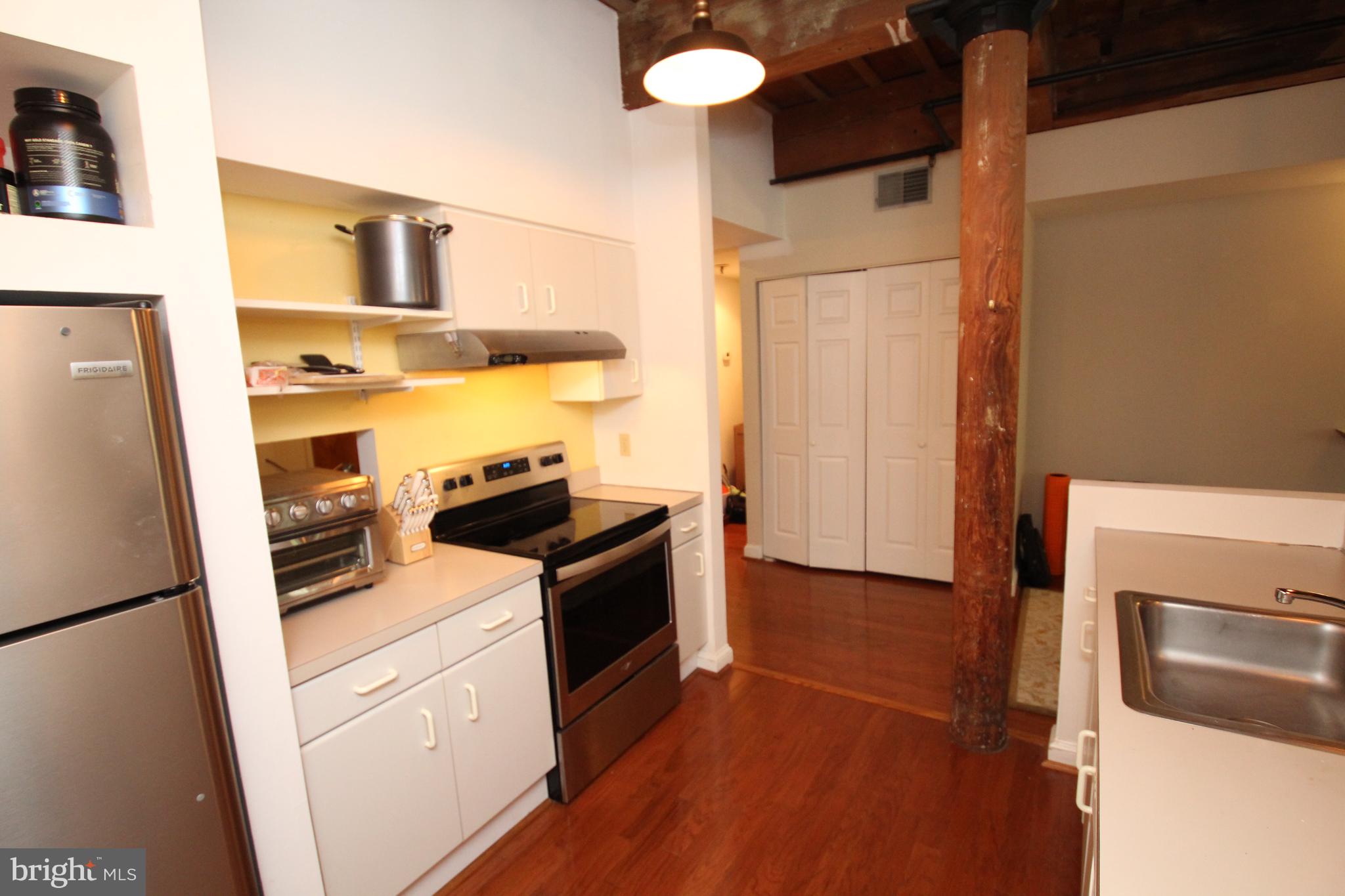 49 Bancroft Mills Road, Unit 3J Wilmington, DE 19806 - Photo 10 of 25 a kitchen with a refrigerator stove and microwave