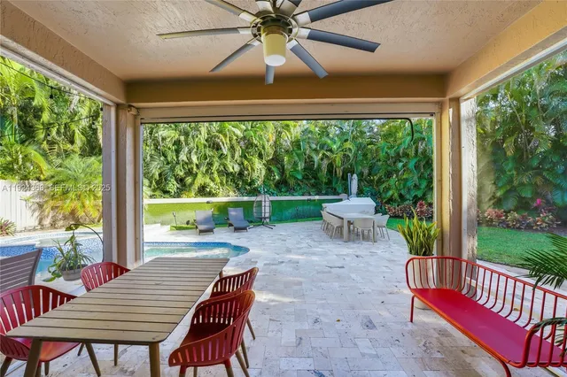 a kitchen with stainless steel appliances kitchen island granite countertop a stove refrigerator and cabinets
