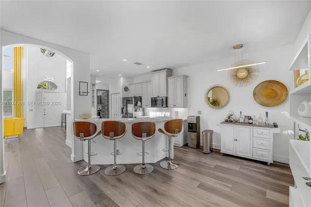 a view of entryway and hall with wooden floor