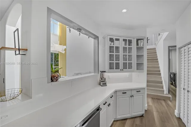a view of a room with a large window and stairs