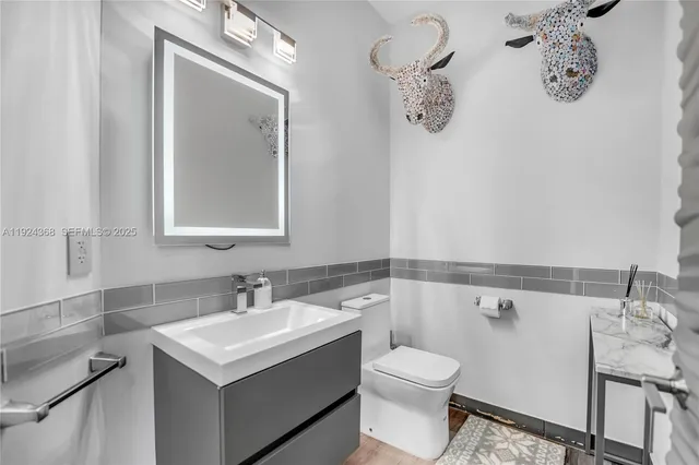 a bathroom with a double vanity sink and mirror with shower