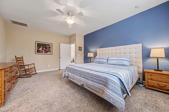 a kitchen with stainless steel appliances granite countertop a refrigerator a stove a sink a dining table and chairs with wooden floor