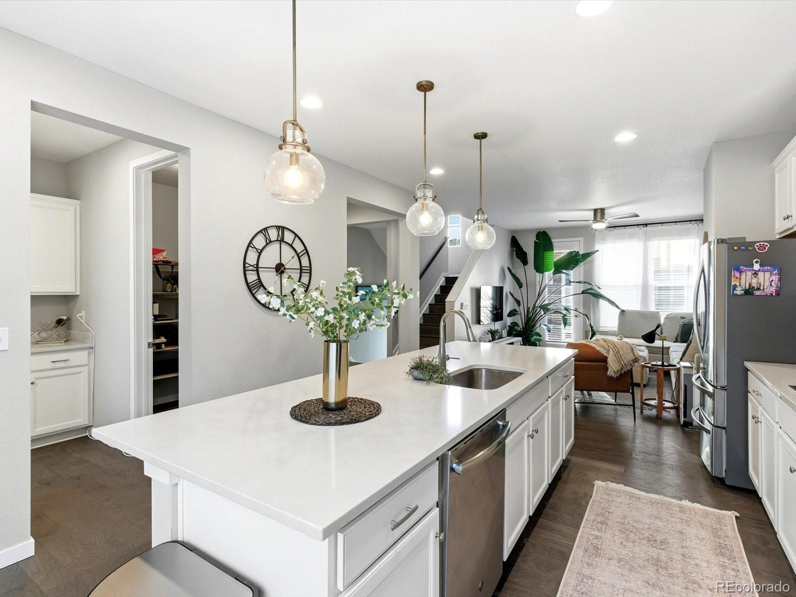 8338 Rivulet Point Highlands Ranch, CO 80129 - Photo 17 of 50 a kitchen with sink and refrigerator