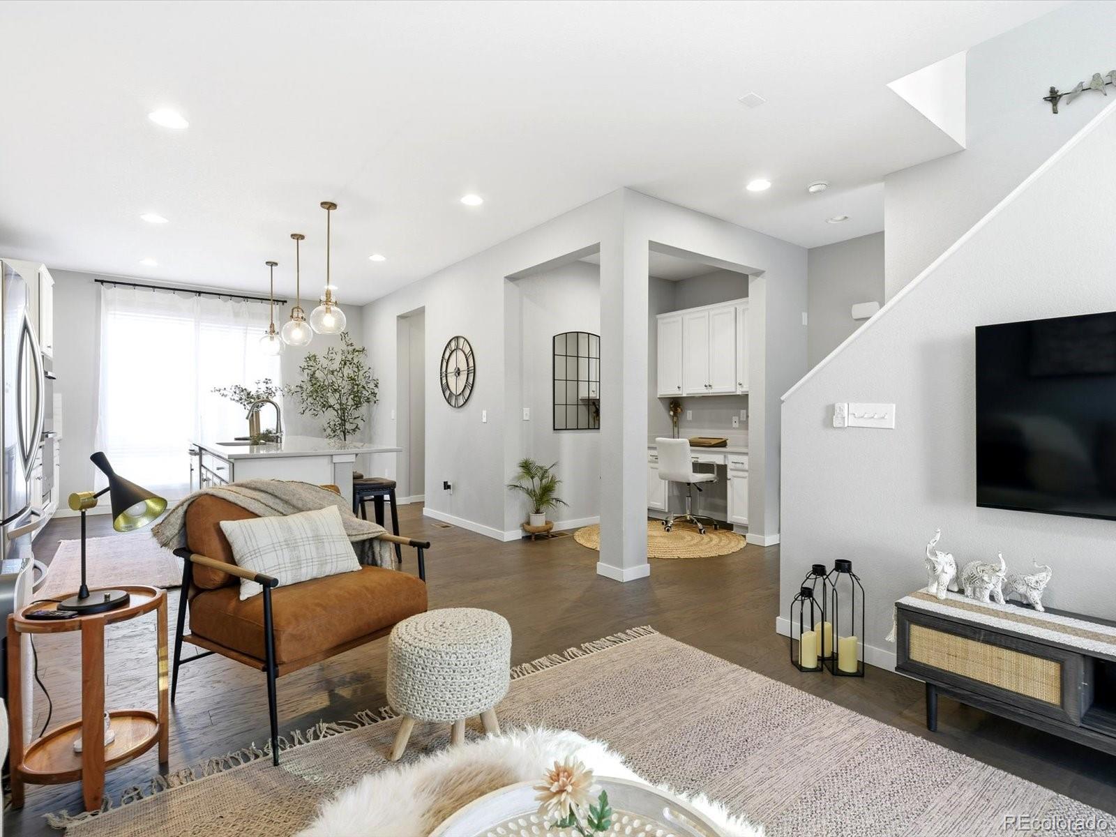 8338 Rivulet Point Highlands Ranch, CO 80129 - Photo 19 of 50 a living room with furniture and a flat screen tv