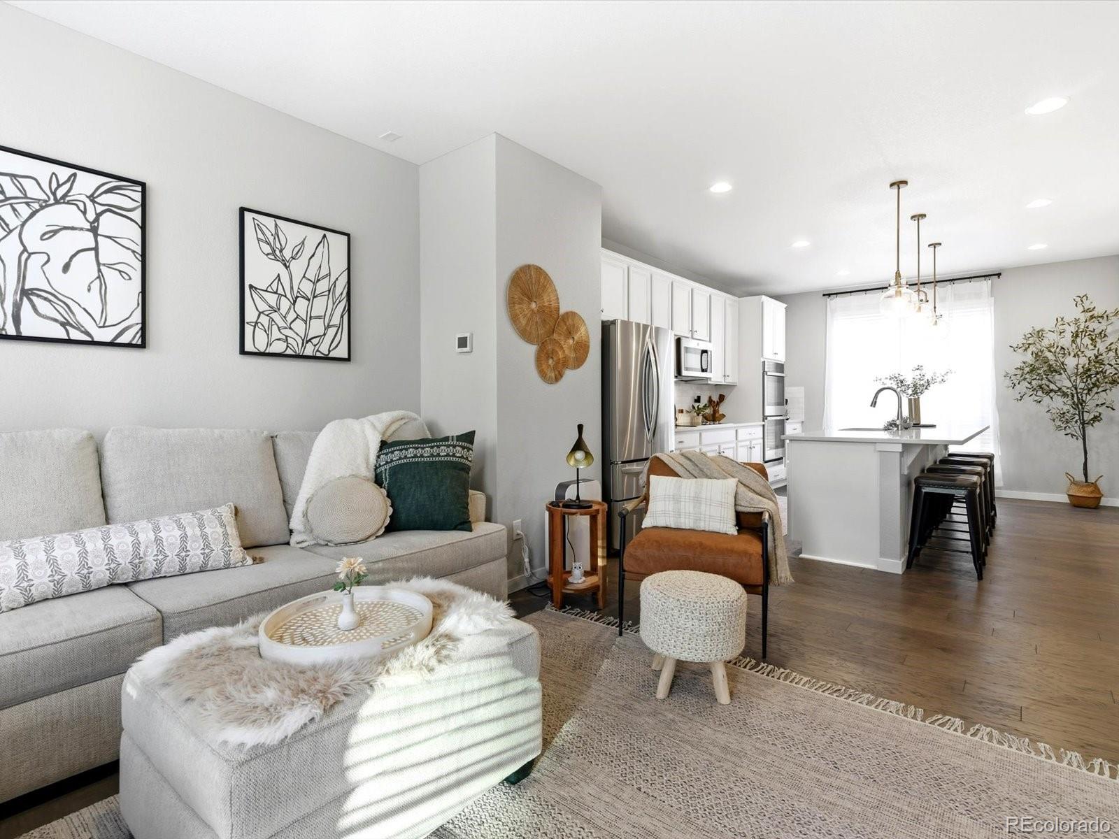 8338 Rivulet Point Highlands Ranch, CO 80129 - Photo 20 of 50 a living room with furniture and kitchen view