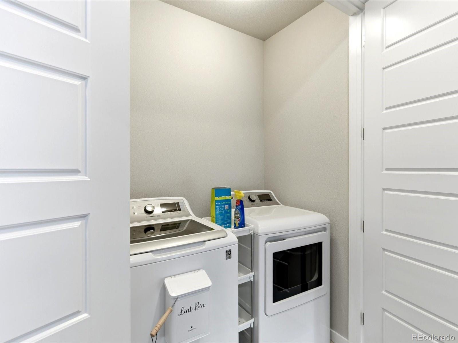 8338 Rivulet Point Highlands Ranch, CO 80129 - Photo 25 of 50 a utility room with dryer and washer