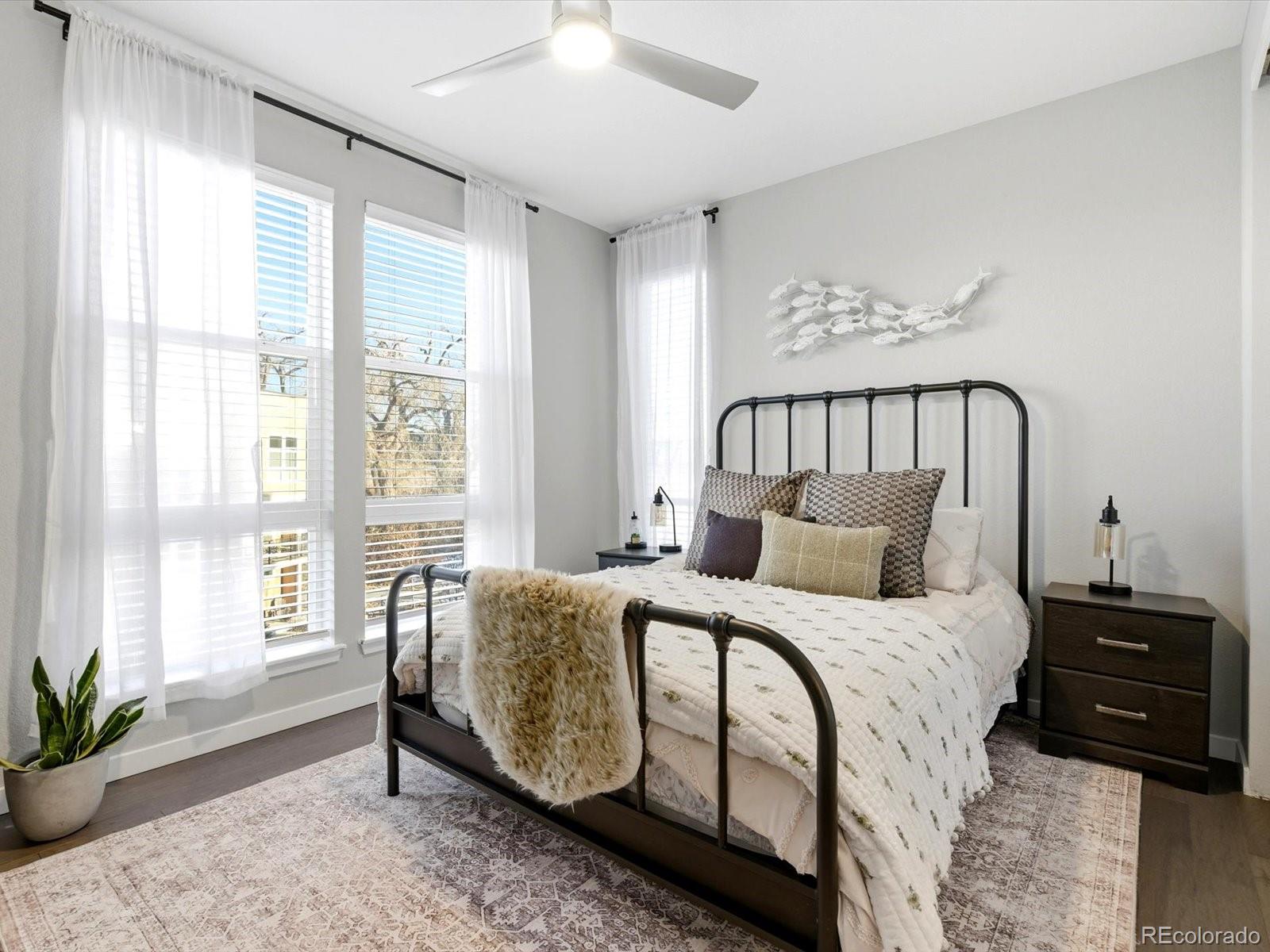 8338 Rivulet Point Highlands Ranch, CO 80129 - Photo 27 of 50 a bedroom with a large bed and a potted plant