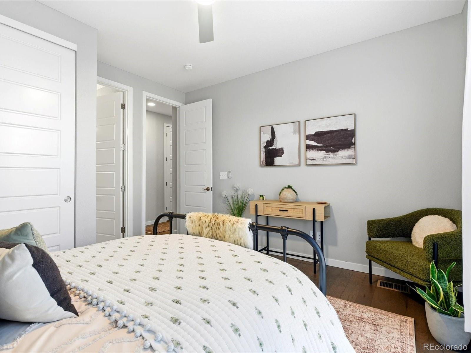 8338 Rivulet Point Highlands Ranch, CO 80129 - Photo 28 of 50 a bedroom with a bed and a chair