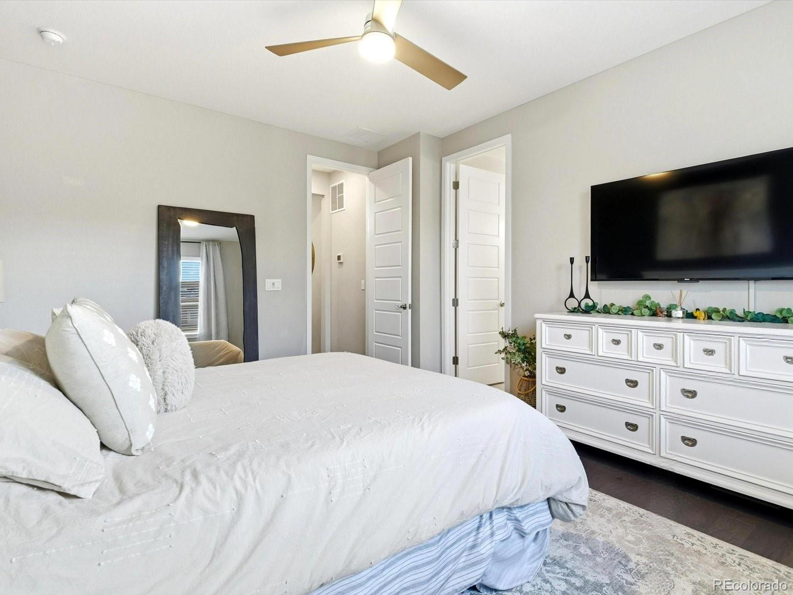 8338 Rivulet Point Highlands Ranch, CO 80129 - Photo 31 of 50 a bedroom with a bed and a flat screen tv