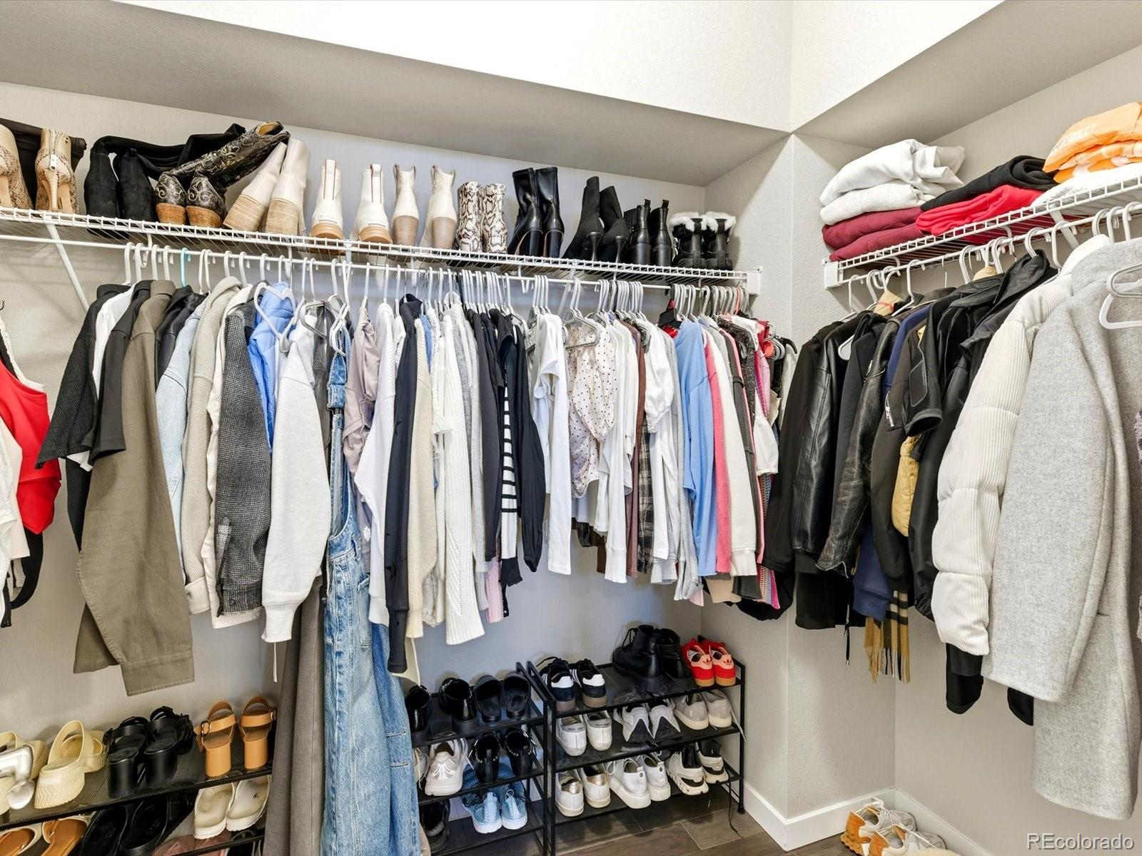8338 Rivulet Point Highlands Ranch, CO 80129 - Photo 36 of 50 a view of walk in closet with clothes and shoes