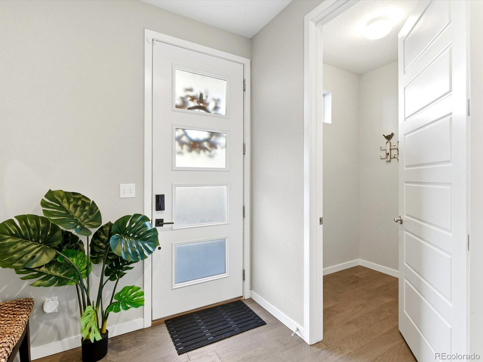 8338 Rivulet Point Highlands Ranch, CO 80129 - Photo 8 of 50 a view of entryway with wooden floor