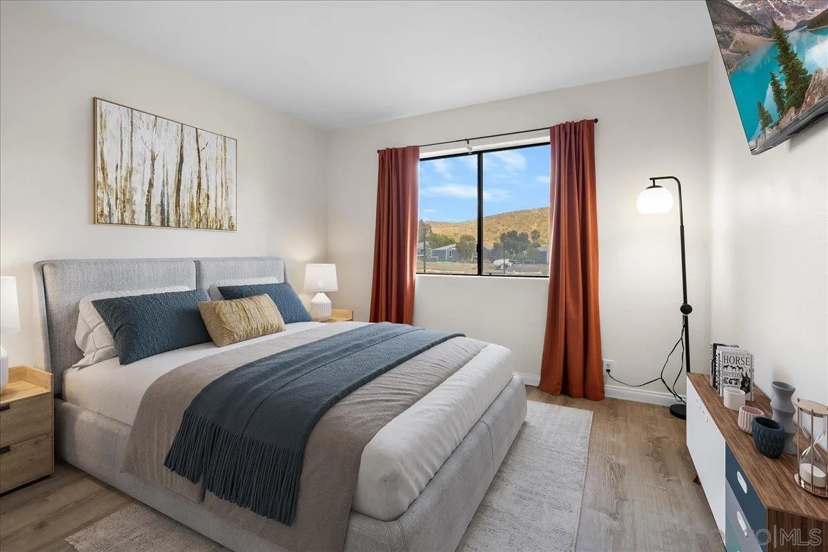 2916 Elm Tree Court Spring Valley, CA 91978 - Photo 14 of 38 a bedroom with a bed and a large mirror next to a window
