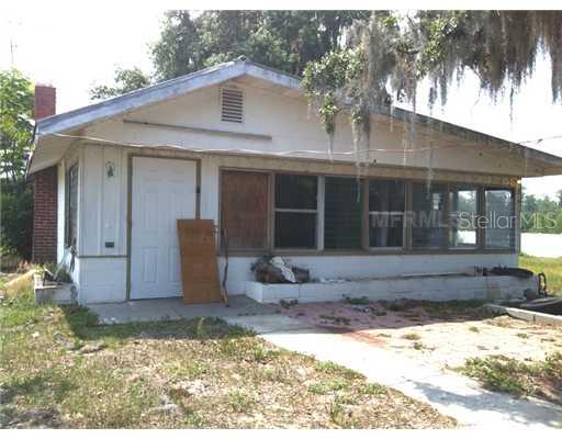 15121 Timber Village Road Groveland, FL 34736 - Photo 1 of 1 a front view of a house with garden